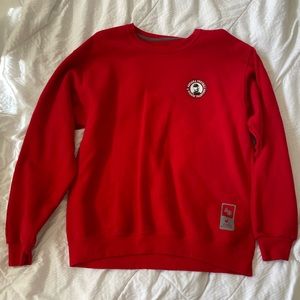 Red crewneck sweatshirt Nebraska Cornhuskers Tom Osborne patch.